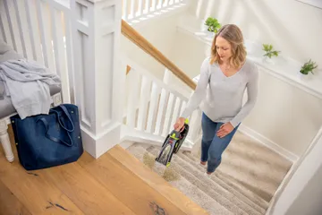 Using Pet Stain Eraser Portable Cleaner to clean stain on stairs.