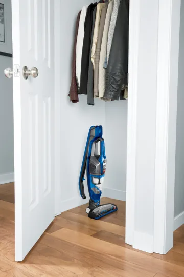 ReadyClean Cordless Stick Vac Handle Folded and machine stored in closet