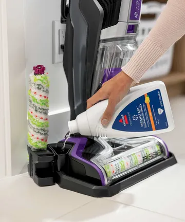 Pouring Self Cleanout formula into storage tray.