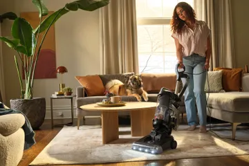 vacuuming area rug around table