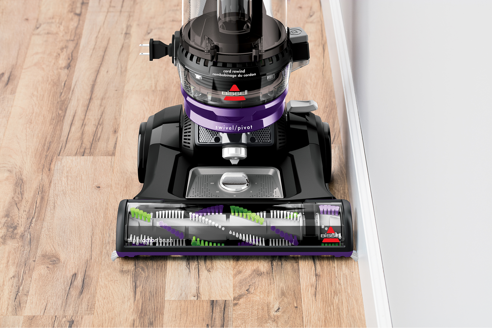 CleanView Swivel Rewind Pet Vacuum vacuuming hard flooring along baseboards.
