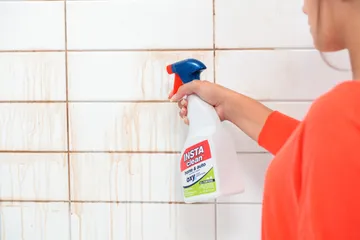 INSTAclean Stain & Odor Remover cleaning shower grout and tiles.