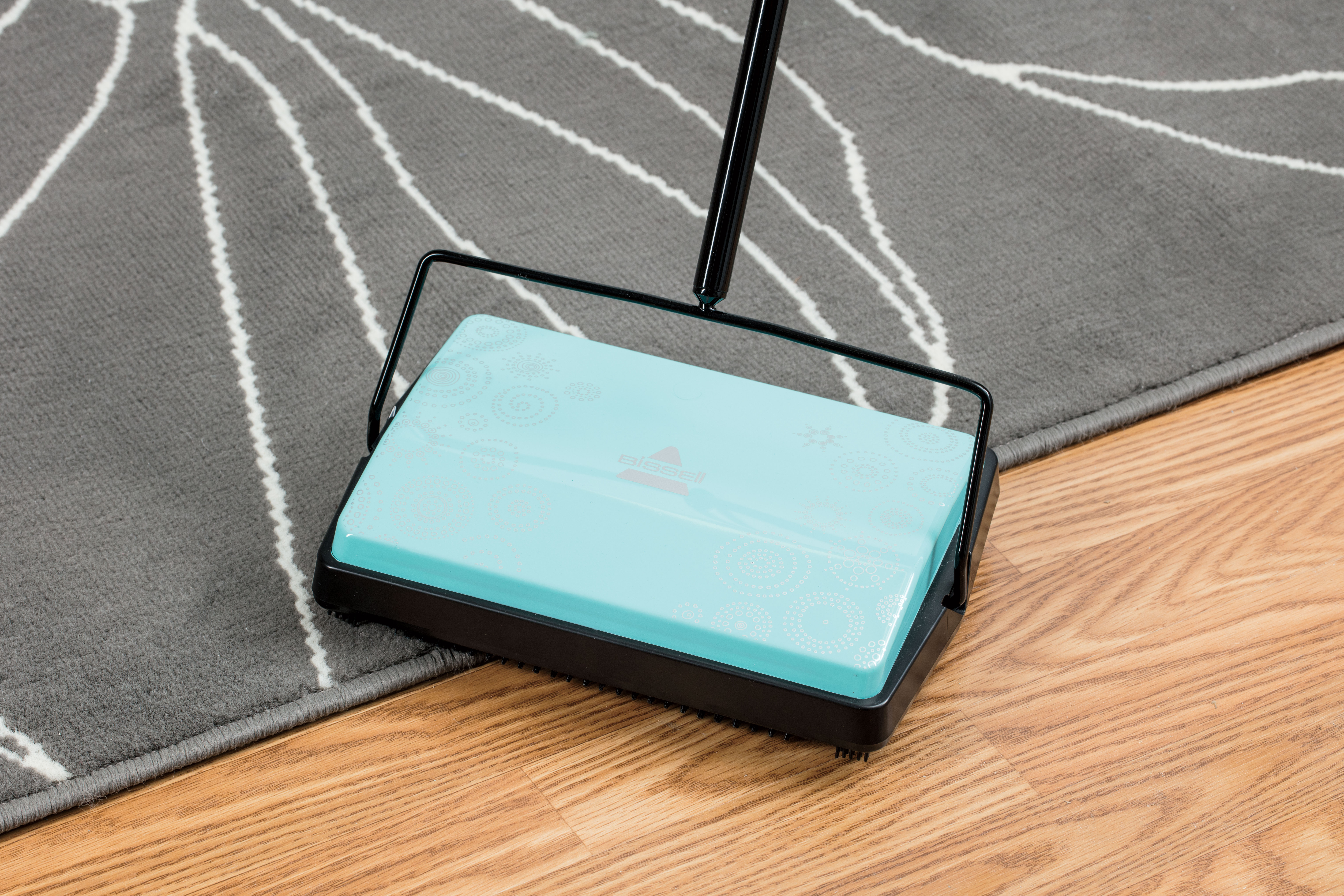 REFRESH Manual Sweeper cleaning on hard floor and area rug.