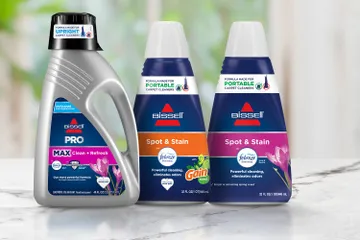 Upright and 2 Portable Febreze Formula Bottles