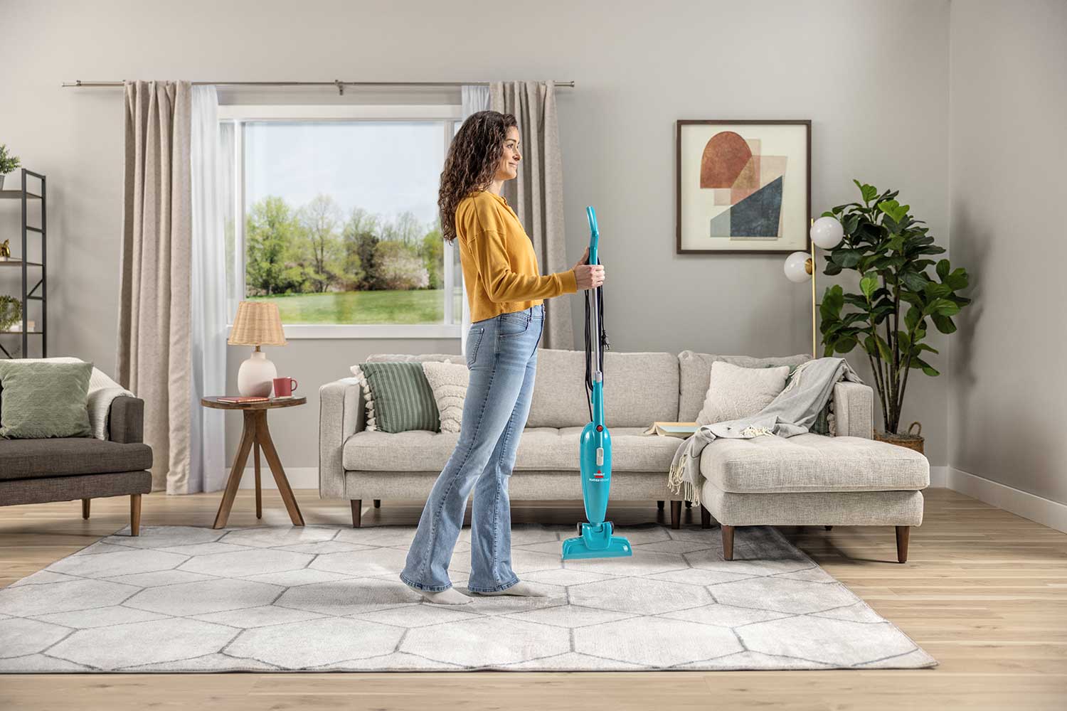  Holding FeatherWeight Stick Vac to add floor nozzle