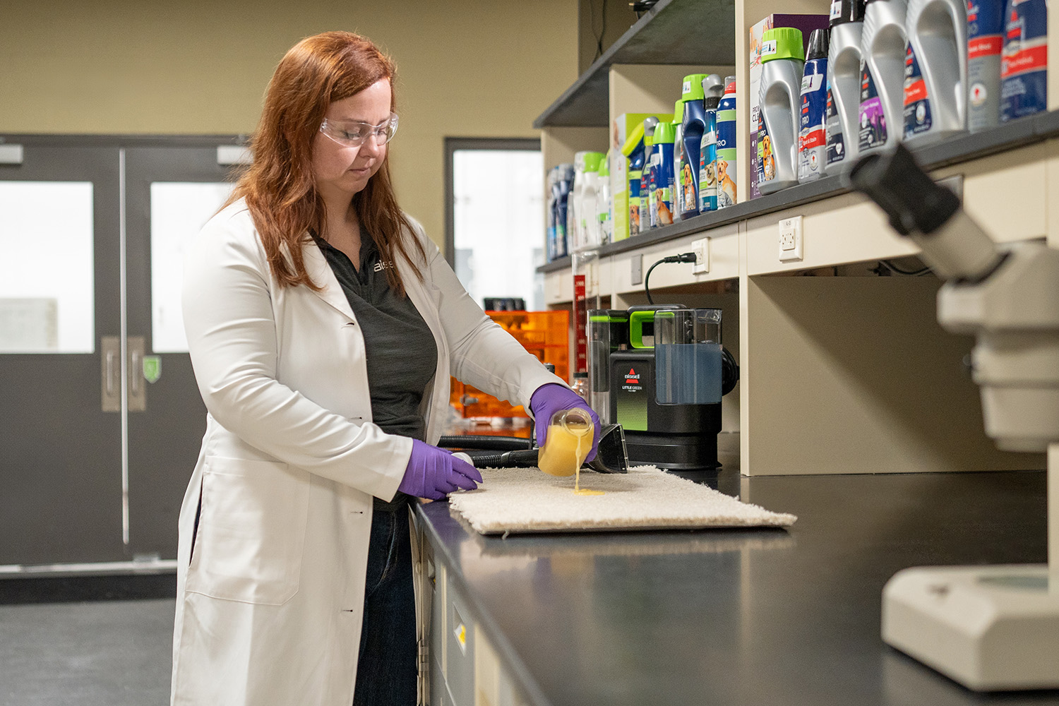 BISSELL scientist testing vomit removal from carpet