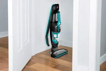 ReadyClean Cordless Stick Vac Handle Folded and machine stored in closet