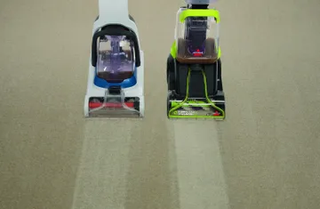 TurboClean PowerBrush Carpet Cleaner next to competitor carpet cleaner deep cleaning carpet.