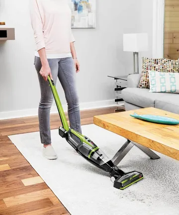 Bending handle of ReadyClean Cordless stick vac to vacuum under furniture.