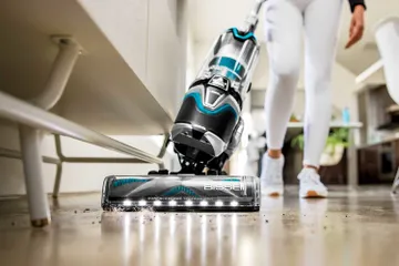SurfaceSense Vacuum Cleaner vacuuming dirt and pet hair from hard flooring.