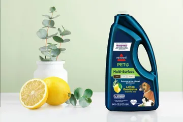 Bottle of PET Multi-Surface Lemon Eucalyptus formula bottle surrounded by lemons