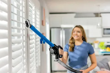 Using Extension wand on hose with dusting brush to clean above floors.