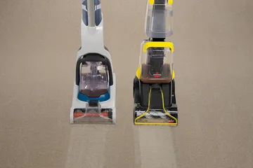 TurboClean PowerBrush Carpet Cleaner next to competitor carpet cleaner deep cleaning carpet.