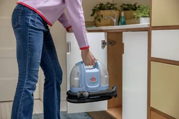 Little Green Mini Portable Carpet Cleaner in storage