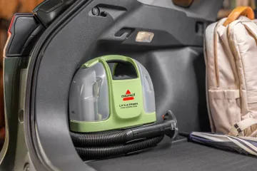 Little Green Mini stored in back of automobile
