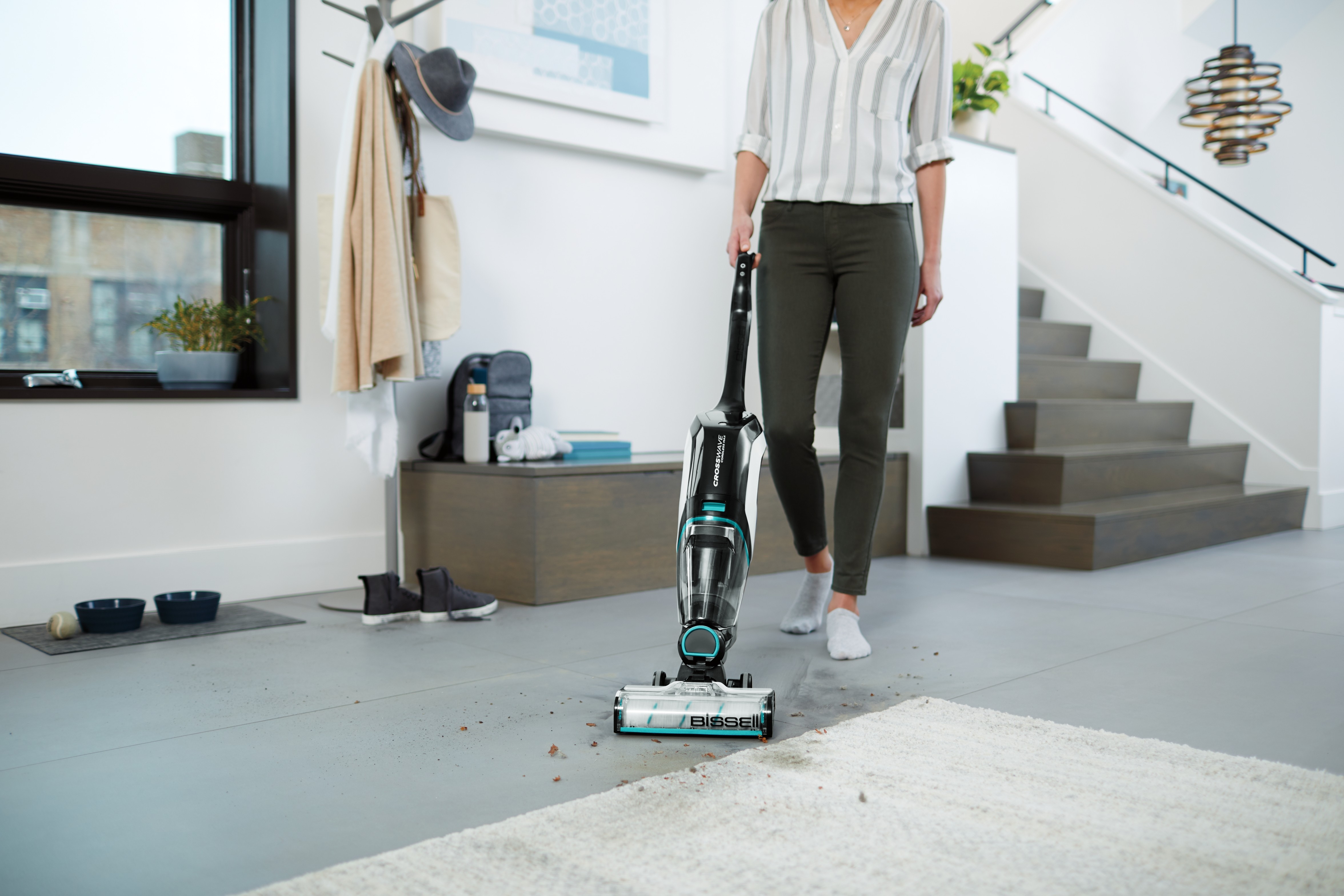 CrossWave Cordless Max using Mutli Surface Brush roll to clean area rug and tiled flooring.