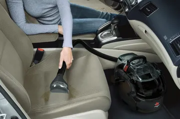 Using SpotClean Pro Portable Carpet Cleaner to clean car interior