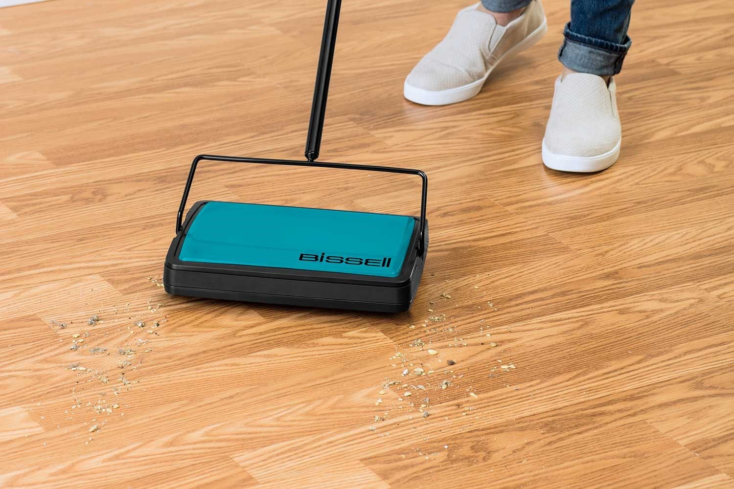 EasySweep Manual Sweeper picking up crumbs from hard flooring.