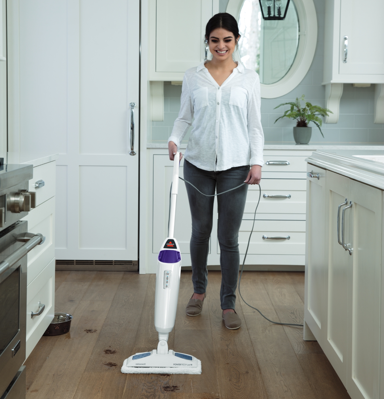 Using PowerFresh Pet Steam Mop to steam paw prints off wood floors. 