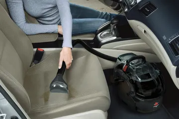 Using SpotClean Pro Portable Carpet Cleaner to clean car interior