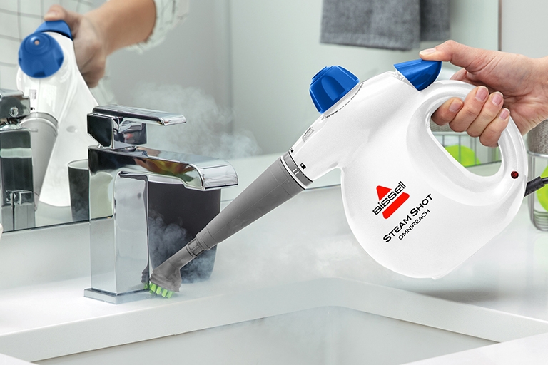 Using Steam Shot OmniForce Handheld Steamer to steam kitchen sink