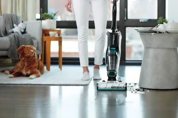 CrossWave Cordless Max cleaning up wet mess off hard flooring in living room.