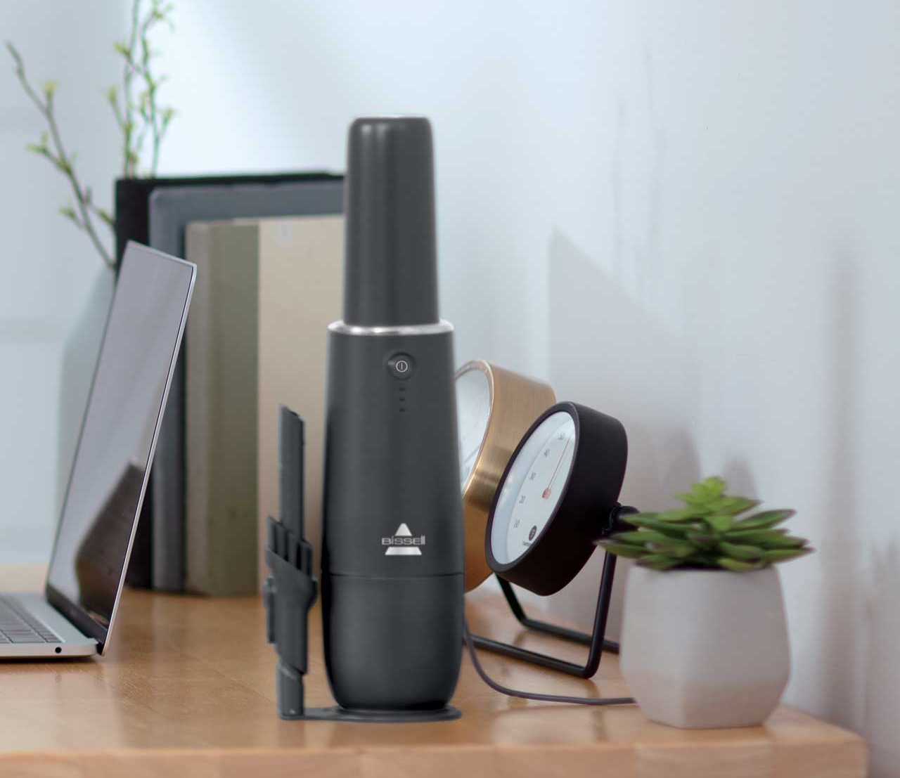 AeroSlim Hand Vac sitting on desk with included attachments 