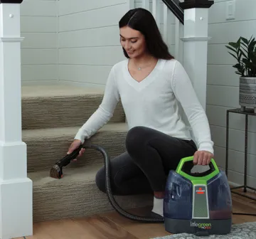 Little Green ProHeat Portable Cleaner cleaning stairs.