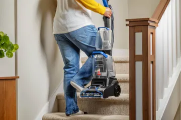 Carrying TurboClean Pet Carpet Cleaner upstairs