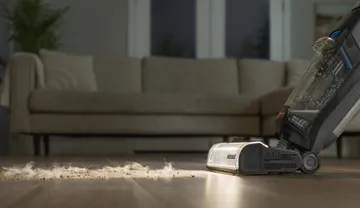 Using headlights on CrossWave OmniFind to vacuum hair and dirt from hard flooring.