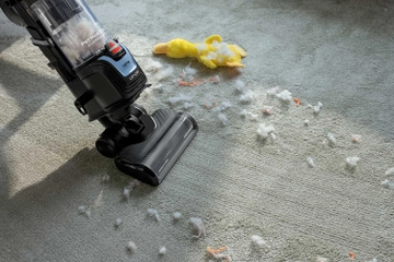 Vacuuming debris from carpet