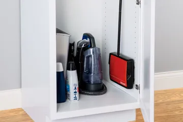 REFRESH Manual Sweeper stored in compact cabinet.