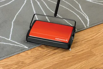REFRESH Manual Sweeper cleaning on area rug and hard flooring.
