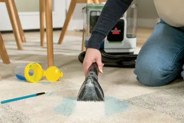 Using portable carpet cleaner to clean spilled paint from carpet