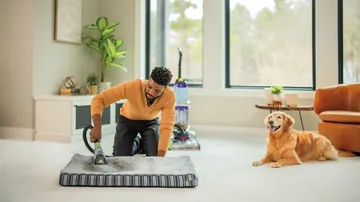 Using Tool on end of hose of ProHeat 2X Revolution Pet Carpet Cleaner to deep clean pet bed.