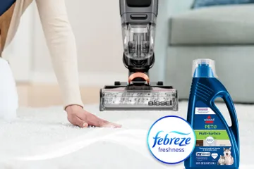 Running hand across dry carpet with bottle of Pet Multi-Surface with Febreze formula bottle and Febreze Logo