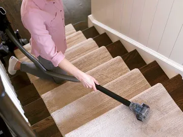 Using Pet TurboEraser Tool on end of hose to vacuum stairs.