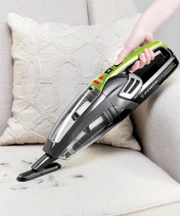 Using Dusting Brush with Pet Hair Eraser Hand Vac to vacuum couch cushion