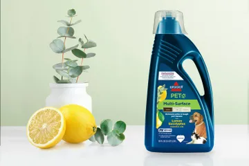 Bottle of PET Multi-Surface Lemon Eucalyptus formula bottle surrounded by lemons