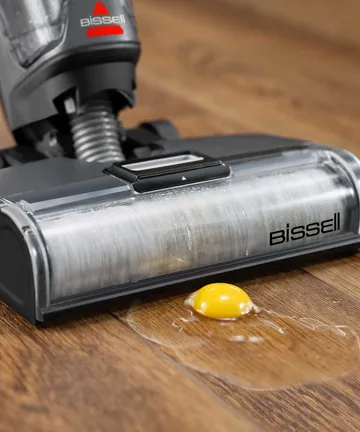 CrossWave OmniForce All-in-One Multi-Surface Cleaner vacuuming egg from hard flooring