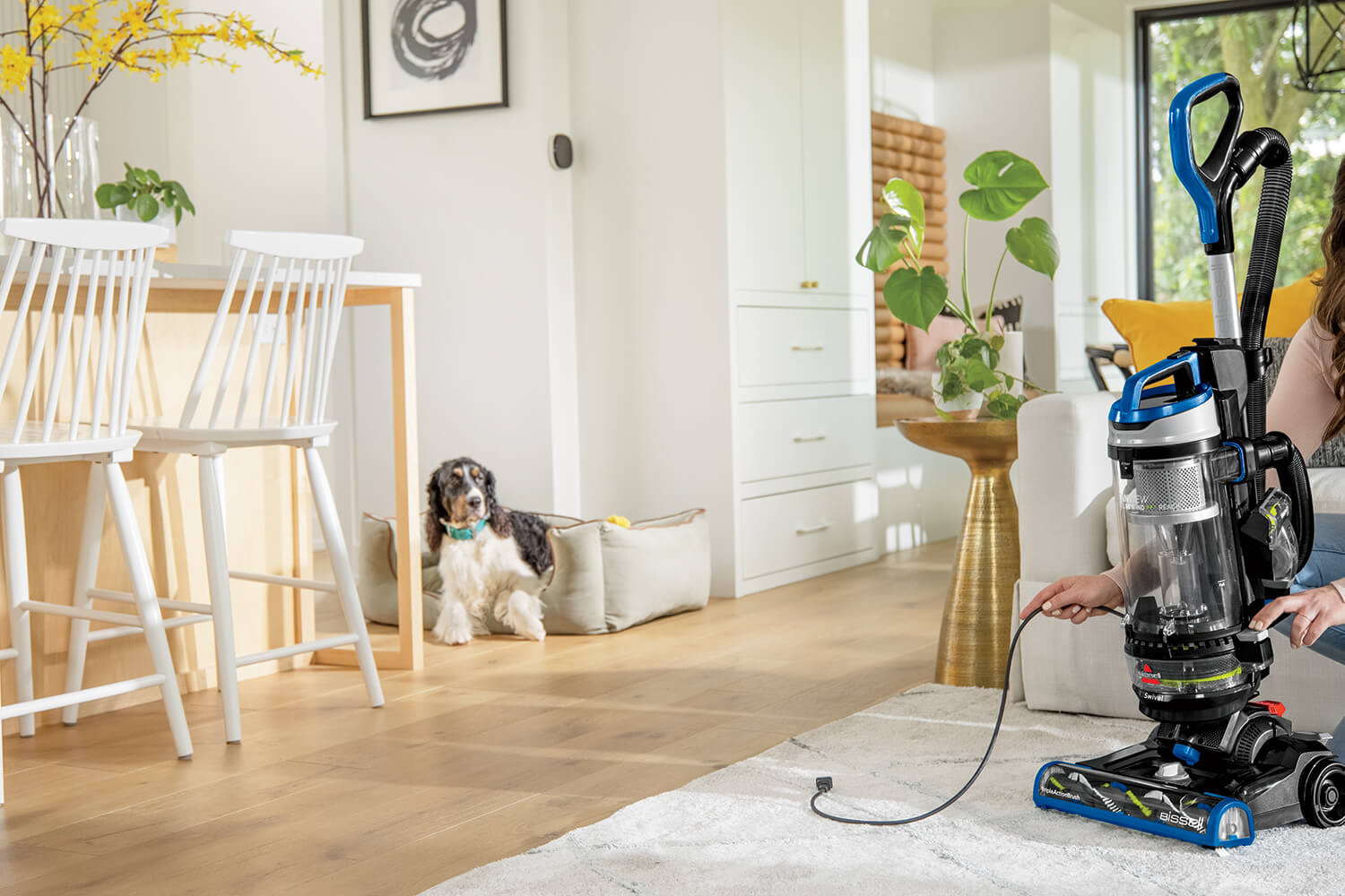 Rewinding cord back into machine of CleanView Swivel Rewind Vacuum. 