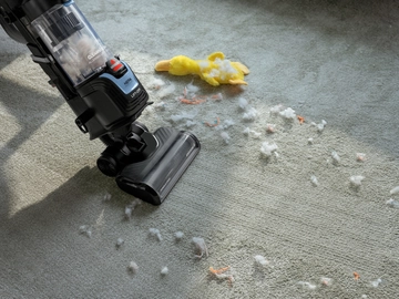 Vacuuming debris from carpet