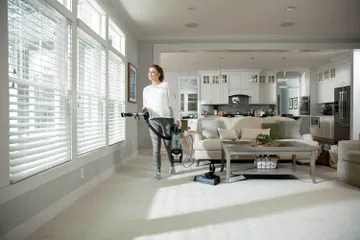 Using pod of vacuum with hose and extension wand to vacuum above floors