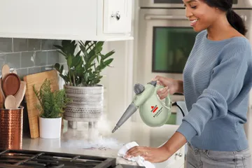 Using Steam Shot OmniForce to steam kitchen counter near stove
