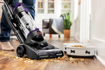CleanView Compact Turbo Vacuum vacuuming dog food from hard flooring.