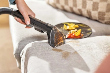 Using Tough Stain Tool to clean spill on couch cushion. 