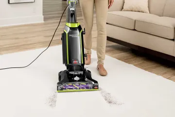 Vacuuming dirt from carpet