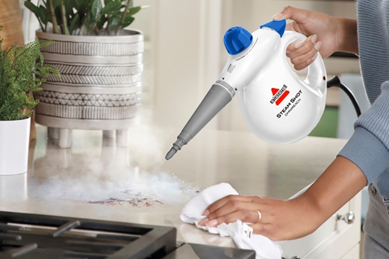 Using Steam Shot OmniForce to steam kitchen counter near stove