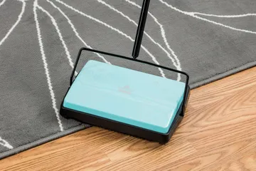REFRESH Manual Sweeper cleaning on hard floor and area rug.