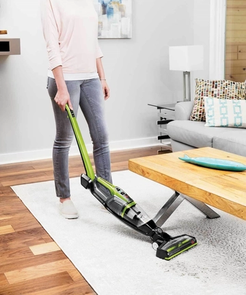 Bending handle of ReadyClean Cordless stick vac to vacuum under furniture.
